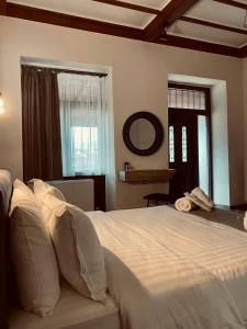 a bedroom with a large white bed and a window at 11 Luxury Apartments Metsovo in Metsovo