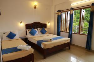 A bed or beds in a room at Periyar Woods