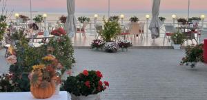 a group of tables and chairs with flowers in vases at Shalanda in Odesa