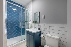 a bathroom with a toilet and a sink and a shower at Bay Tree Apartments in Derby