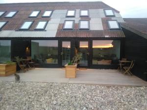 a house with a cat sitting in front of it at Rikke og Franks Svineri in Lemvig