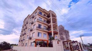 a tall white building with balconies on the side of it at Sshubh Hotel Nathdwara in Nāthdwāra