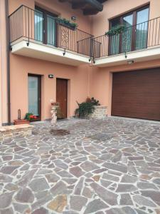 a building with a stone floor in front of a garage at B&B La Casa di Giuliana in Cermignano