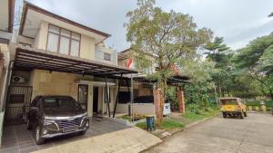 a car parked in front of a house at Atmosfer Guest House Sentul in Bogor