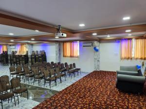 a room with a bunch of chairs and a stage at Vijay Shree Inn in Vellore