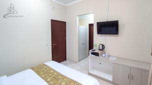 เตียงในห้องที่ Atmosfer Guest House Sentul