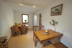 a dining room and living room with a table and chairs at Haus Felsental in Rathen