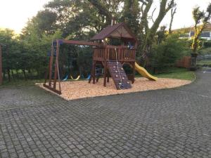a small playground with a slide and a slideintend at Belton House Holiday Home in Wanlockhead