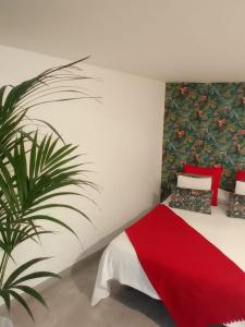 a bedroom with a red bed and a plant at APARTAMENTO LA CRUCILLADA in La Guancha