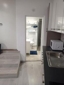 a kitchen with a sink and an open refrigerator at APARTAMENTO LA CRUCILLADA in La Guancha +22 photos