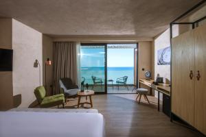 a hotel room with a bed and a view of the ocean at Chania Flair Boutique Hotel, Adults only, Tapestry Collection by Hilton in Chania Town +82 photos