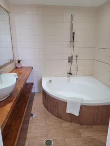 a bathroom with a bath tub and a sink at view point relax in Eilat +10 photos