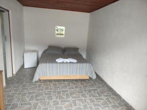 Säng eller sängar i ett rum på Pousada e restaurante Além das Nuvens