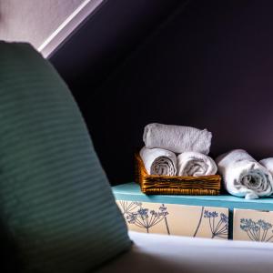 a bunch of towels in baskets on a shelf at The Residence at Bolenna in Perranporth