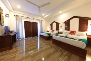 Posteľ alebo postele v izbe v ubytovaní Sundaras Resort & Spa Dambulla