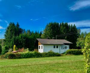 a small white house in the middle of a field at Villa Vorkastell in Börfink