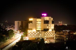 a lit up building with a neon sign on top of it at Regenta Central Udaipur, Court Circle in Udaipur