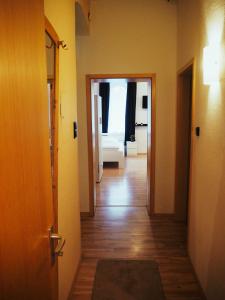 a hallway with a door open to a room at Monteurwohnung in Nuremberg