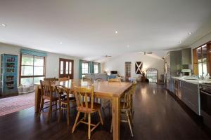 a kitchen and dining room with a wooden table and chairs at Gumtree Glen in Kangaroo Valley