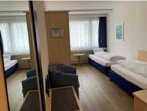 Postel nebo postele na pokoji v ubytování Hotel Blumenstein Self-Check In