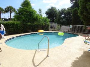 a swimming pool with two frisbees in it at Ruskin Inn Tampa-Sun City Center in Ruskin