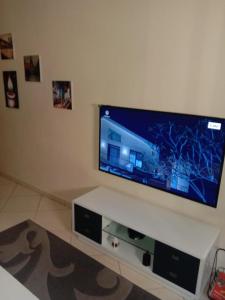 a living room with a large flat screen tv at Suite Apartment Fawzi in Agadir