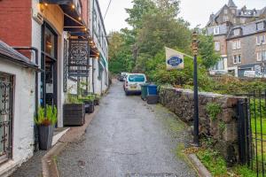 a street with cars parked on the side of a building at Premium 2 Bed Apt 1st floor sleeps 4 adults in Oban town in Oban