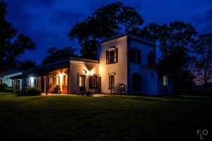 an old house at night with lights on at Estancia La Sofia in San Andrés de Giles