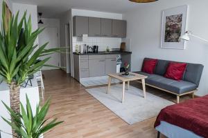 uma sala de estar com um sofá e uma mesa em FULL HOUSE Studios - Southern Prime Apartment em Leipzig