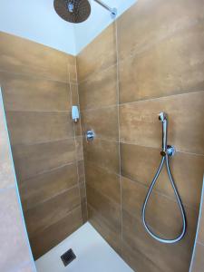 een badkamer met een douche en houten wanden bij ToSuite - Alba Moretta in Alba +11 foto's