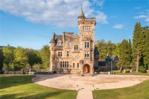 an old castle with a tower on top of it at DOLLARBEG CASTLE - The Tower - Luxury Apartment in Dollar