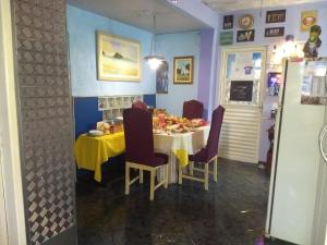 a dining room with a table with food on it at MZ Hostel in Campo Grande