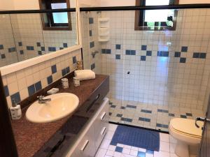 a bathroom with a sink and a toilet at Ouro Sobre Azul Apart Hotel in Arraial d'Ajuda