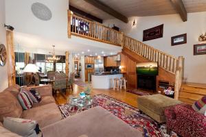 a living room with a couch and a tv and a staircase at Tamarron PineCone 854 in Durango