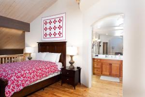 a bedroom with a bed and a bathroom with a sink at Tamarron PineCone 854 in Durango +32 photos
