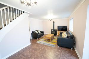 a living room with two couches and a tv at Longley Farm View -spacious 3 Bed Property in Sheffield