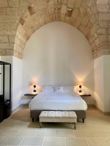 a bedroom with a bed and two lamps on two tables at Villa Di Noi in Arnesano +74 photos