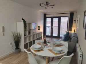 a dining room and living room with a table and chairs at Fantastic centrally located 1 bed apartment in Liverpool