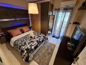 a bedroom with a bed with a teddy bear on it at Luxury Home in Spata +130 photos