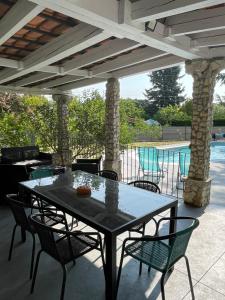 a black table and chairs on a patio at Villa Camille in Céreste