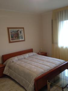 Un pat sau paturi într-o cameră la B&B Morosini