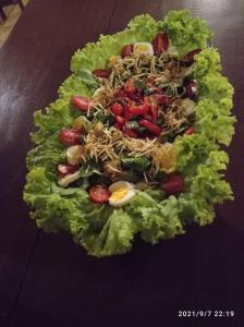 een salade met sla en tomaten op tafel bij Palma Adventure Hostel in Barreirinhas