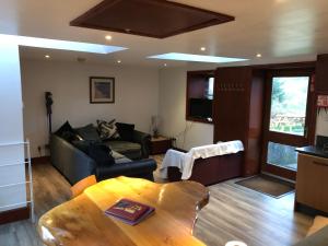 a living room with a couch and a table at Ochiltree cottage in Newton Stewart