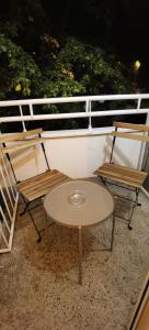 two chairs and a table on a balcony at Studio apartman Tonka in Vinkovci