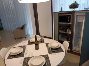 a white dining room table with a bottle of wine on it at Vecchia Bastia Lodge in Castelfranco Veneto