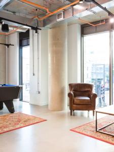 a room with a chair and a pool table at Chic Studios at Chapter Highbury II in London in London