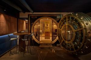 a room with a large wooden barrel and a bar at voco The Hague by IHG in The Hague