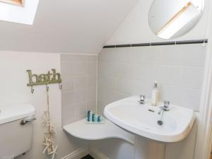 a bathroom with a sink and a toilet at Barn Cottage in York +17 photos