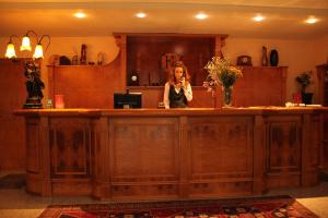 a woman standing at a counter in a room at Hotel Sporting in Tabiano