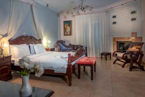 a bedroom with a large bed and a fireplace at Pozar Salt Cave Hotel Spa in Kato Loutraki